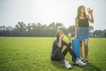 two asian woman athelic in green fieldの写真素材