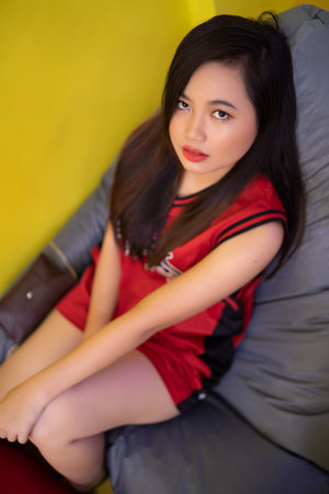 asian teenage relaxing on a bean bagの写真素材