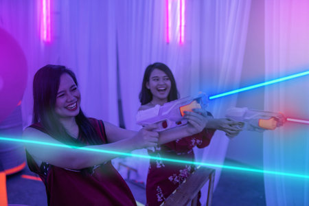 asian teenage playing laser tag indoorの写真素材
