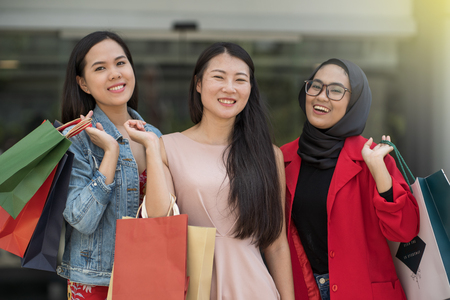 young asian friends shopping spree at shopping mallの写真素材