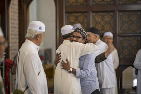 shah alam, malaysia - 15 february 2019. Man newly converted to Islam congrats by fellow muslim in a mosqueのeditorial素材