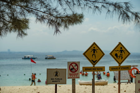 asian warning sign at the beach for more careful