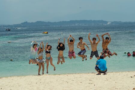 Malaysia - 15 aug 2019, group of tourist taking a jump picture with sea as a backgroundの写真素材