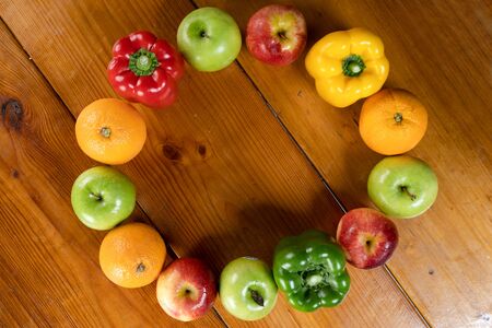 circle fruit and vegetable with a brown wooden backgroundの写真素材