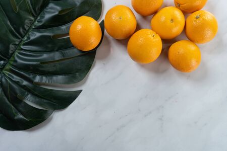 oranges and green leaf with marble backgroundの写真素材