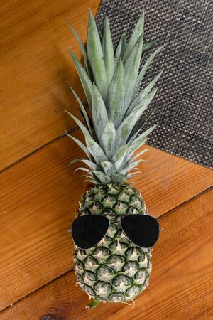 spectacular pineapple with wooden backgroundの写真素材