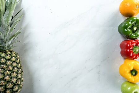pineapple and capsicum with white marble backgroundの写真素材