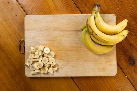 wooden background with yellow bananaの写真素材