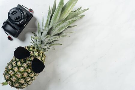 pineapple and camera with marble backgroundの写真素材