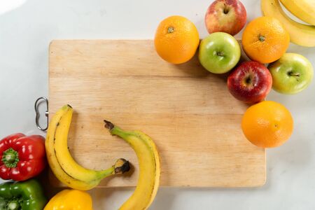 fruits on chopping board with white marble backgroundの写真素材