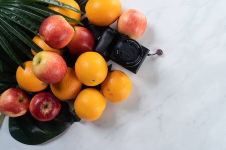 tropical fruits and camera with marble backgroundの写真素材