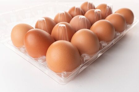 Close up shot fresh chicken eggs isolated on whiteの写真素材