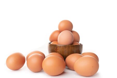 brown chicken eggs isolated in white backgroundの写真素材