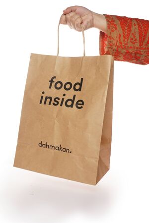 Shah Alam, Malaysia - 1 November 2019, Dah Makan take away paper bag isolated on a White backgroundのeditorial素材