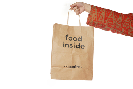 Shah Alam, Malaysia - 1 November 2019, Dah Makan take away paper bag isolated on a White backgroundのeditorial素材