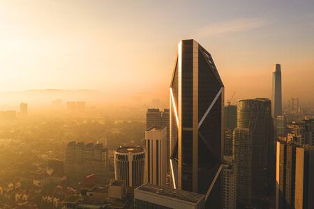 kuala lumpur buildings with dramatic sunrise aerial shotの写真素材