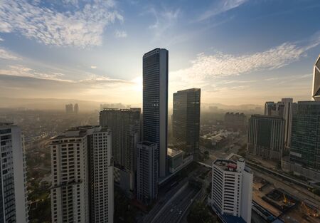 kuala lumpur with large tower building silhouette with dramatic sunriseの写真素材