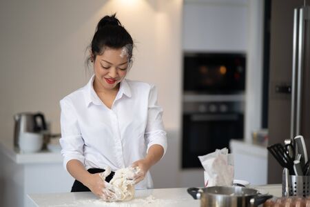 The action of the woman making the breadの写真素材
