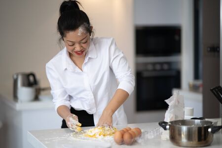 The action of the woman making the breadの写真素材