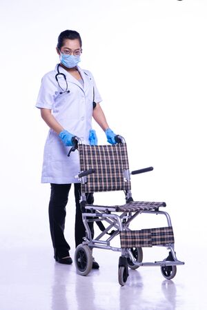 Doctor with wheelchair. On a white backgroundの写真素材