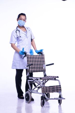 Doctor with wheelchair. On a white backgroundの写真素材