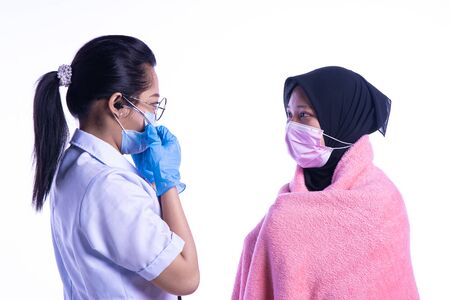 The doctor is examining the patient's heart condition. On a white background.の写真素材