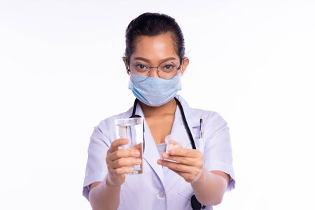 Doctors wear masks while showing medicine and waterの写真素材