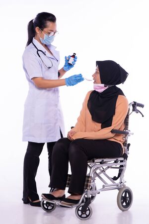 The doctor who is giving the patient the medicineの写真素材