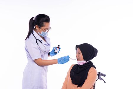 The doctor who is giving the patient the medicineの写真素材