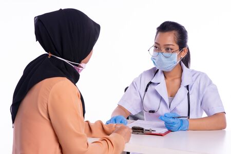 The doctor is taking evidence from the patientの写真素材