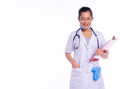 Woman doctor standing with folder on white backgroundの写真素材