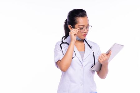 Woman doctor standing with folder on white backgroundの写真素材