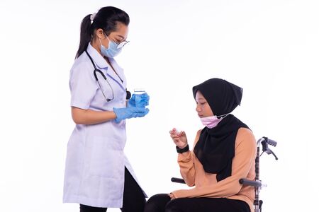 The doctor who is giving the patient the medicineの写真素材