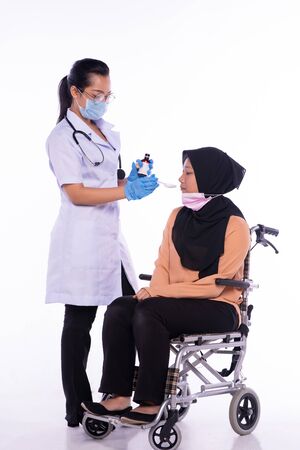 The doctor who is giving the patient the medicineの写真素材