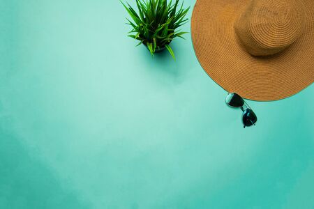 flat lay of brown beach hat on turquoise backgroundの写真素材