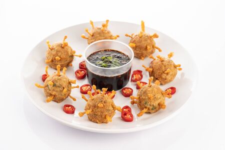fried steamed tofu with minced meat and enoki mushroom on white backgroundの写真素材