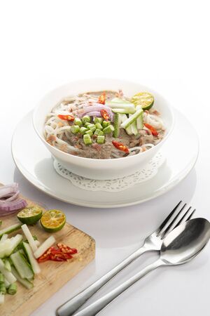 laksa with thick noodles and chicken on white bowl and backgroundの写真素材