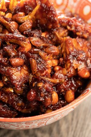 friend tempeh with hot soy sauce in a decorated bowlの写真素材