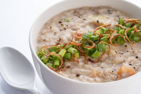ramadhan famous food bubur lambuk in a white bowl and backgroundの写真素材