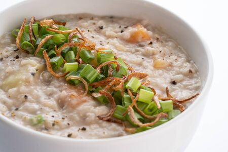ramadhan famous food bubur lambuk in a white bowl and backgroundの写真素材