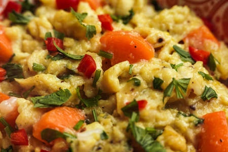 delicious scramble egg on printed bowl and black background close up shotの写真素材