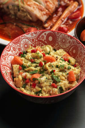delicious scramble egg on printed bowl and black backgroundの写真素材