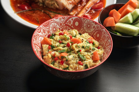 delicious scramble egg on printed bowl and black backgroundの写真素材