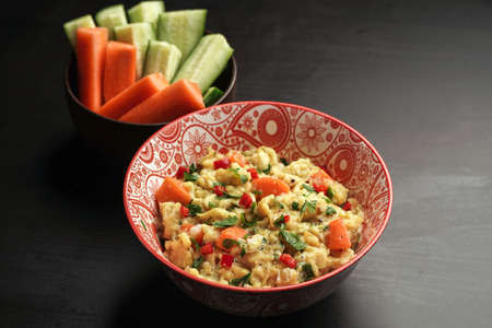 delicious scramble egg on printed bowl and black backgroundの写真素材