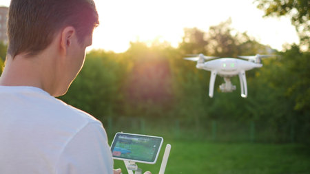 The operator remotely controls the drone. The flight of the drone