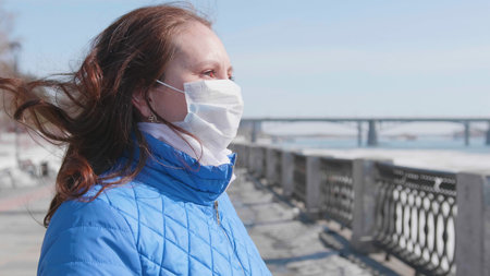 A girl in a protective mask on the street. Prevention and protection of health and safety of life....