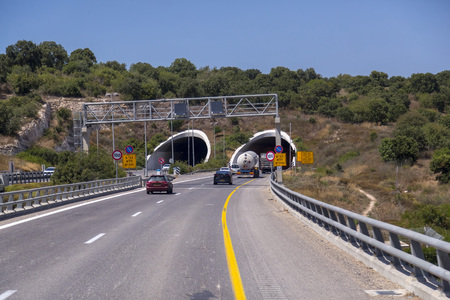 Jerusalem to Haifa, Israel - June 17, 2018: Highway with signs and vehicles in traffic from Jerusalem to Haifa on a sunny summer day.