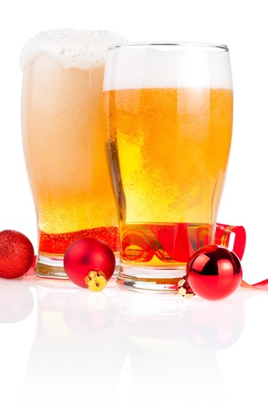 Two glasses fresh lager beer, Red ribbon and Christmas Balls isolated on white backgroundの写真素材