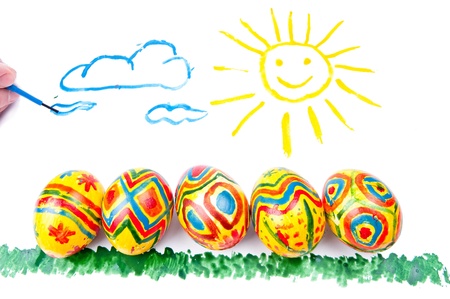 Child s picture by a water-colour  five easter eggs on a grass, a sun in sky with cloudsの写真素材