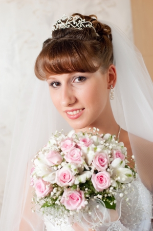 Beautiful bride posing in her wedding dayの写真素材